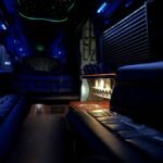 Interior view of 15-passenger party van with LED lighting and mini bar setup – Brantford Limo.