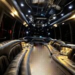 Wide view of luxury interior in 30-passenger party bus with glossy black ceiling and full bar setup – Brantford Limo.