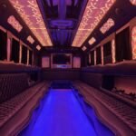 Red and violet LED interior party bus with quilted seating and TV – Brantford Limo.
