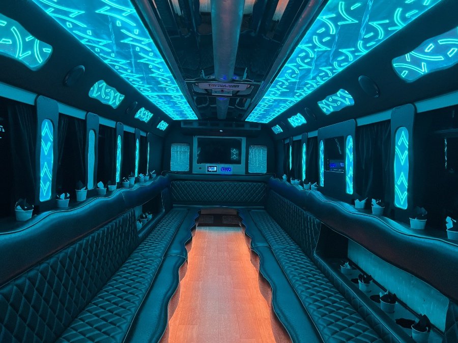 30-passenger party bus with bright teal LED ceiling and wood-style floor – Brantford Limo.