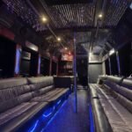 Interior of 38-passenger party limo bus with leather seating, LED lights, and dance pole – Brantford Limo.