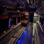 Interior of 38-passenger party limo bus with leather seating, LED lights, and dance pole – Brantford Limo.