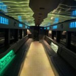 Interior view of luxury 50-passenger party limo bus with leather seating and glowing LED ceiling – Brantford Limo.