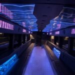 Vibrant interior of 50-passenger party bus with purple and blue LED lights – Brantford Limo Rentals.