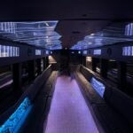Stylish 50-passenger limo bus interior with sleek leather seats and soft blue LED lighting – Brantford Limousine.
