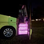 Illuminated entry stairs of 50-passenger party bus at night – Brantford Limousine Services.